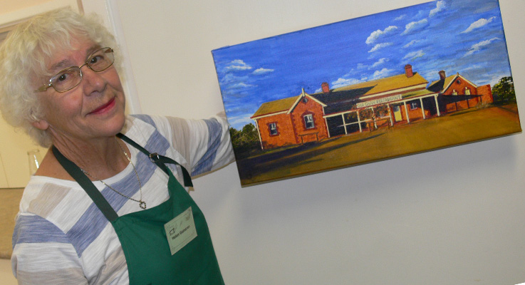 Helen Germeren proudly displaying a painting completed at the U3A Art Day