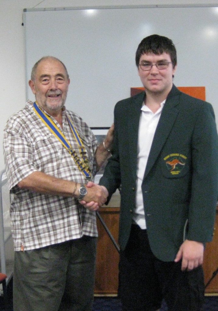 Rotary Club President Geoff Latona presenting Cordel Murphy with his Rotary blazer.