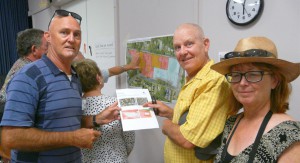  Hawks Nest/Tea Gardens Progress Association President Trevor Jennings with James and Cathriona Kelly from Ezy Kayaks - examining Council’s proposed zoning changes.