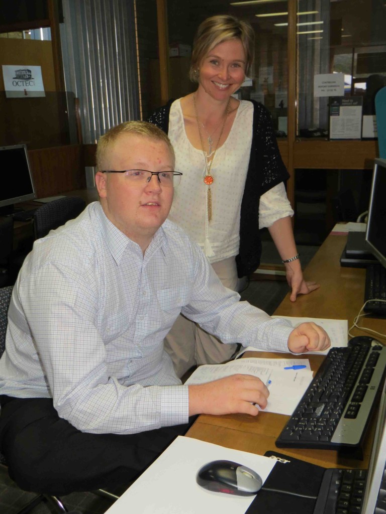 Rural Transaction Centre Customer Service Officer Kim Kent guides Douglas Martin on his first day of work. 