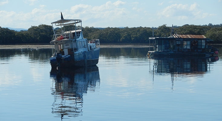 Large vessel in the Myall River had been driven on to the sand flats.