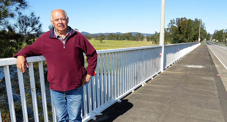 HONOUR: Dennis Syron proudly stands on the Nan Syron Bridge. 