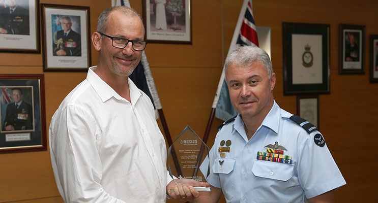 : Williamtown Blood Challenge Co-ordinator, Mr Samuel Hays presents Senior Australian Defence Force Officer – RAAF Base Williamtown, Air Commodore Craig Heap CSC, with the 2015 Australian Red Cross Blood Challenge Regional Trophy 