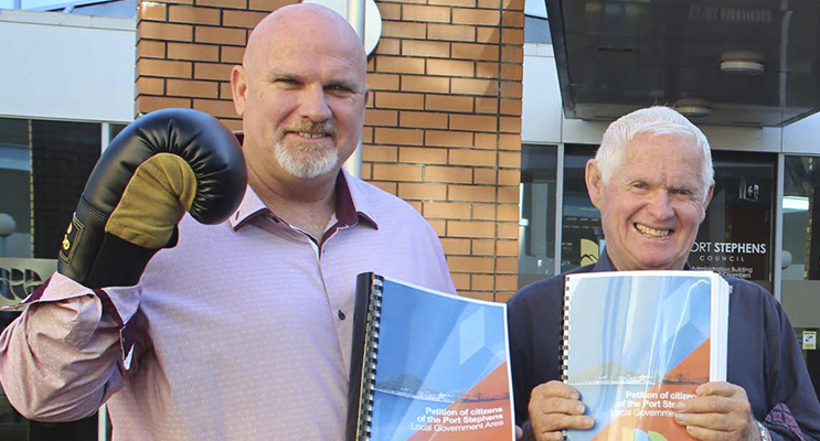 Councillor and Deputy Mayor Chris Doohan with Mayor Bruce MacKenzie holding Anti-merger petition orgainiser earlier this year.