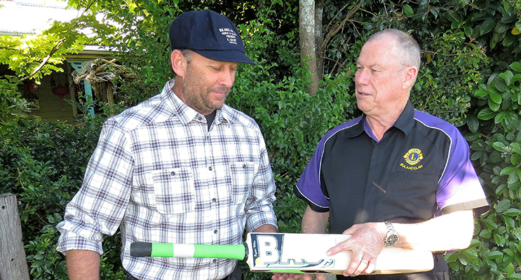 NEW INNINGS: Bradley Allen and Roger Dixon with the bat signed by Michael Clarke.