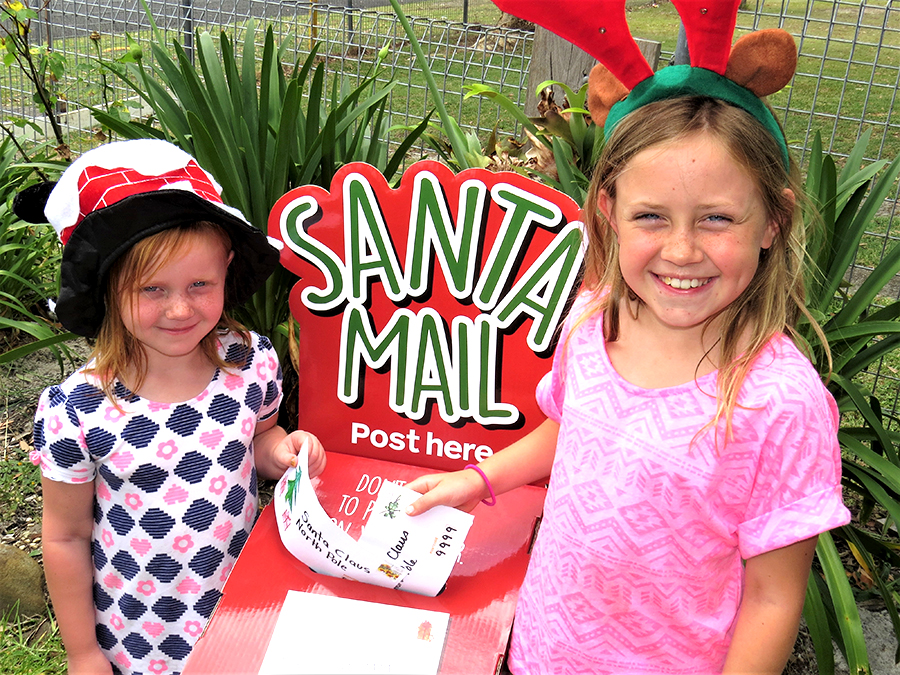 SANTA’S MAILBOX: Mia and Charlie Garemyn post their letters to Santa.