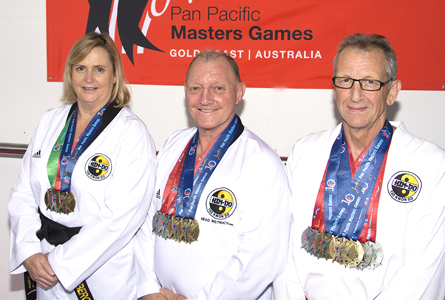 Liz Bergan, Ronald Bergan and Dave Kilroy of Him-Do Tae Kwon Do Academy with medals from Pan Pacific Masters Games.