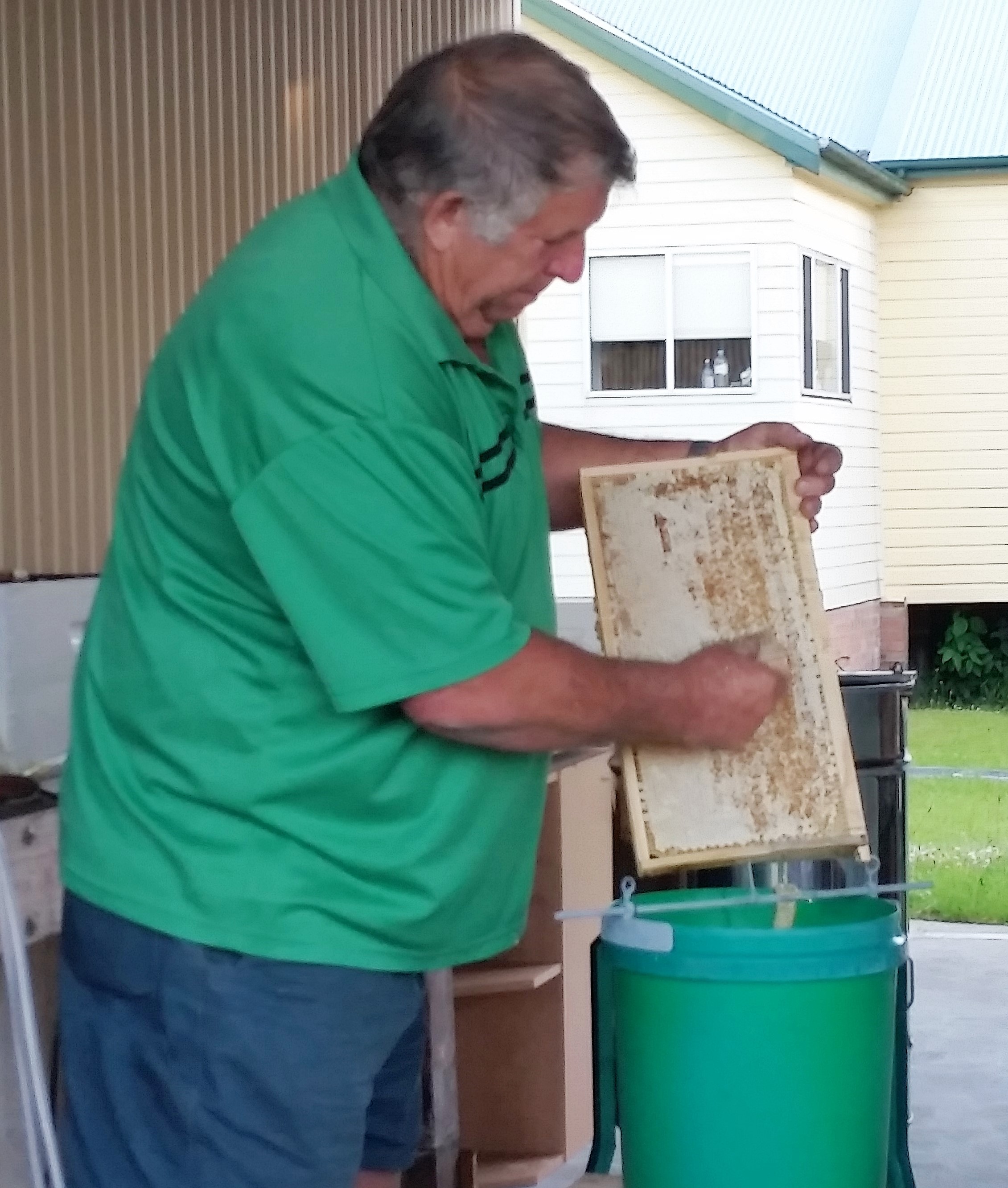 HONEY: Gary Haynes uses a scraper to remove the wax