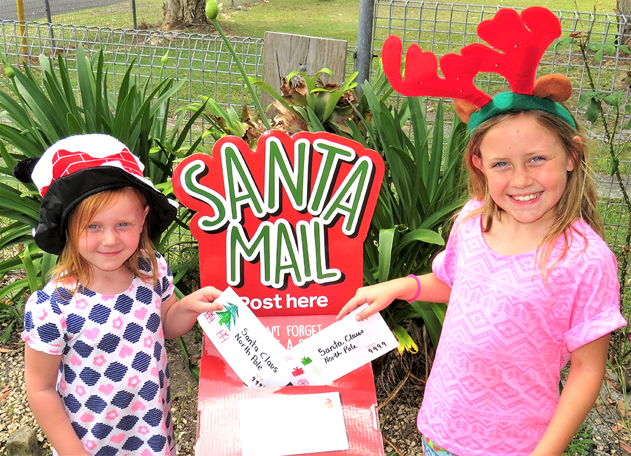 SANTA’S MAILBOX: Mia and Charlie Garemyn post their letters to Santa.