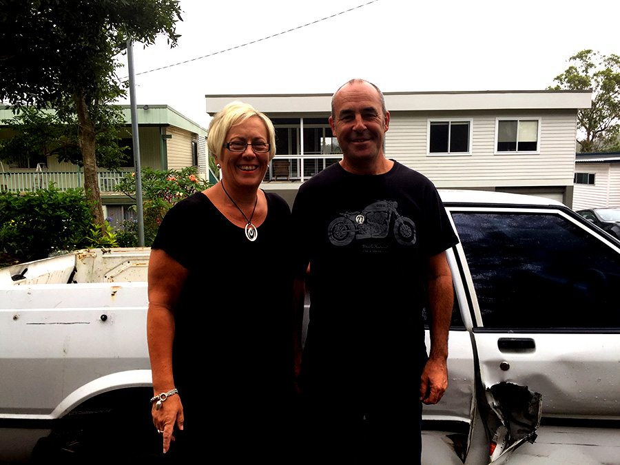 Bettina and Paul Brooke with their damaged vehicle. Photo by Jo Finn