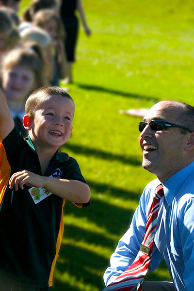 St Philip’s Christian College’s Principal in 2011 Chris Walkling with student Padriac Jones. Photo: Supplied