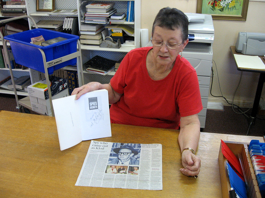 Lemon Tree librarian Marcia Lancaster with the signed book and a press clipping featuring our Master Spy.