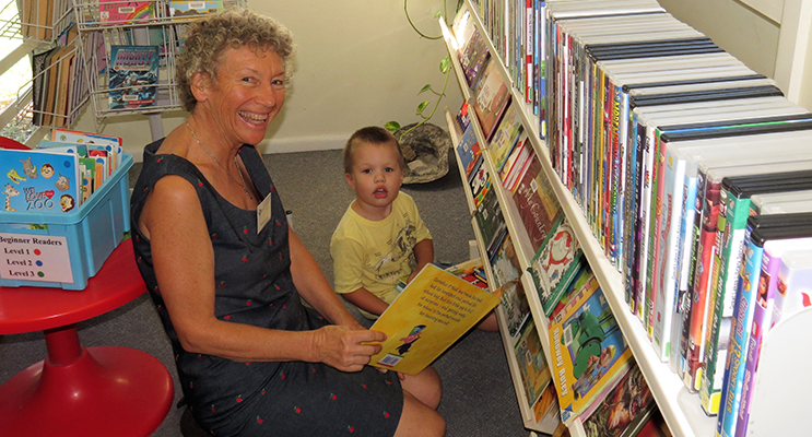 Volunteer librarian Beatrice Weeks with young reader Jack Dexter.