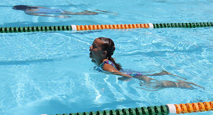 Swimming Carnival: KPS student Lexi puts in a huge effort in the breaststroke event.  