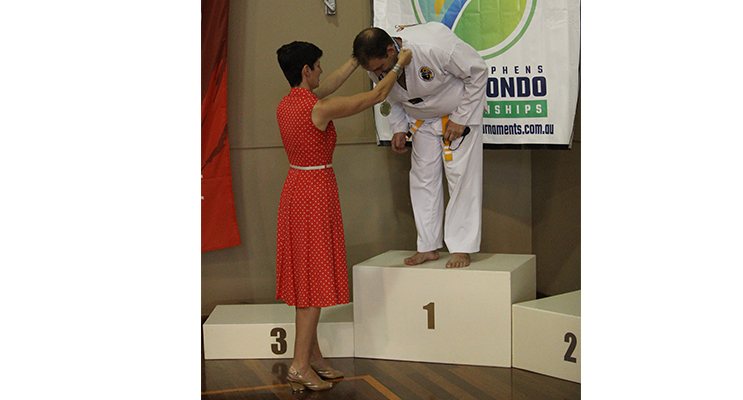 Kate Washington presenting a medal at Port Stephens Taekwondo Championships.