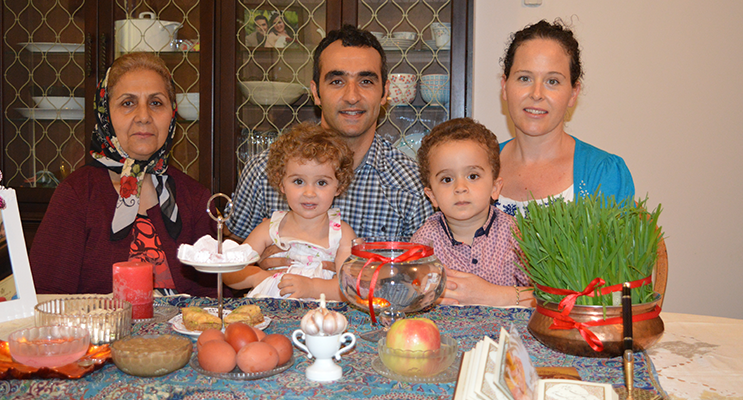 Sitting at the prepared Persian New Year table is Nasrin Aminakbari, Nima Nikfarjam, Erica Nikfarjam, with children Bernadette and Christopher.
