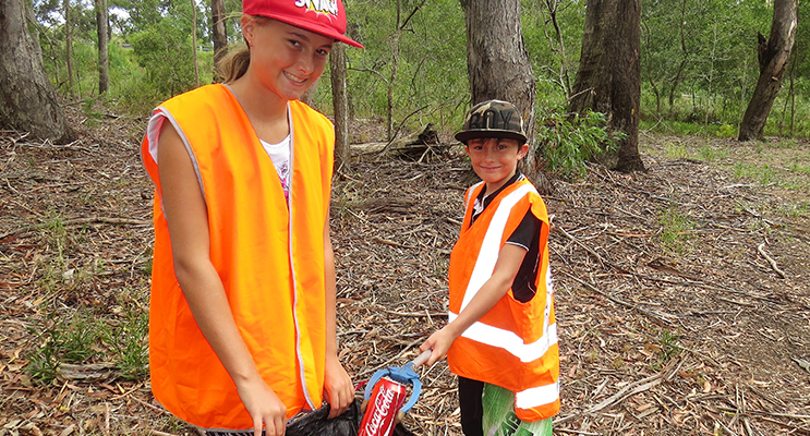 : Clean Up: Amber Cunningham and her brother Corey pick up rubbish left in the Mountain Park at Bulahdelah