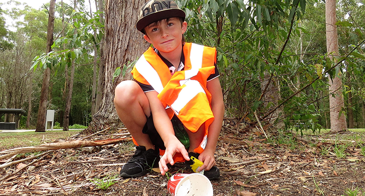 Clean Up: Nine-year-old Corey Cunningham picks up rubbish left by others. 