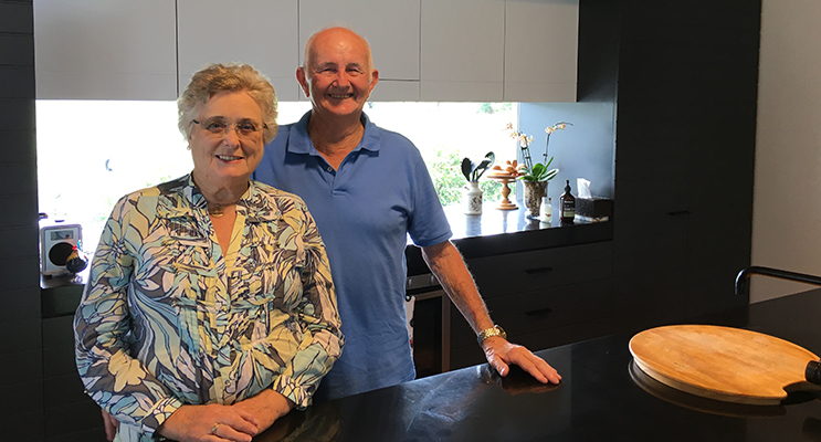 The home’s owners, Diana and Geoffrey Hamilton, in front of the Ned Kelly-style kitchen windows.