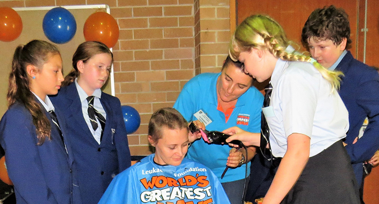: Maggie Cunich shaves Mrs O’Connell’s head with hairdresser Renee Ballantine and captains Maddi Tassell, Grace Kiehne and Oliver Gibbs. 