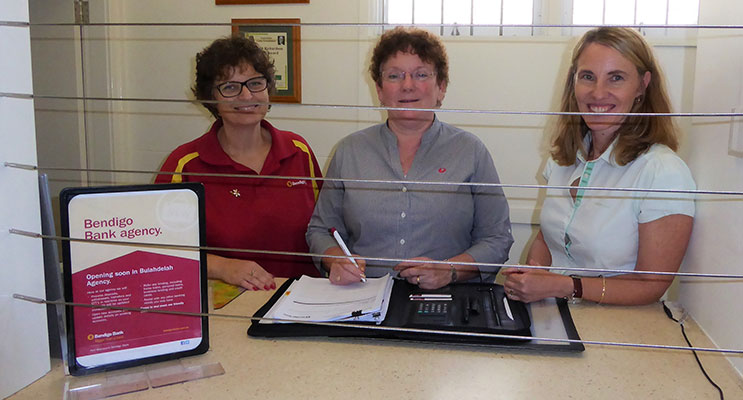 Bendigo Bank Area Manager Kim Rowley, Agent Judy Dixon and Port Macquarie Branch Manager Kerry Lumby sign contracts for the Bulahdelah Agency. Photo: Supplied.