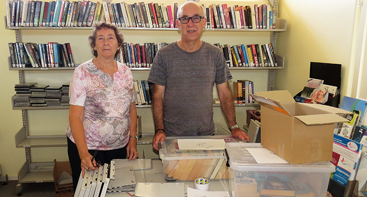 Loraine Farrell and MidCoast Library Services Manager Chris Jones dismantle the library.