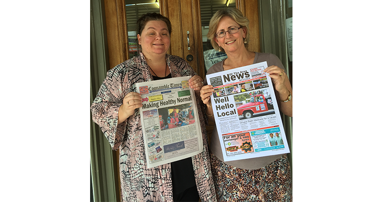 Rachael Vaughan and Lee O’Connor trade papers outside the Coonamble Times office.