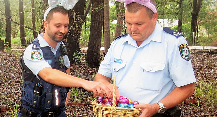 Senior Constables Feeney and Mcleod examine the chocolate eggs allegedly left by the Easter Bunny.