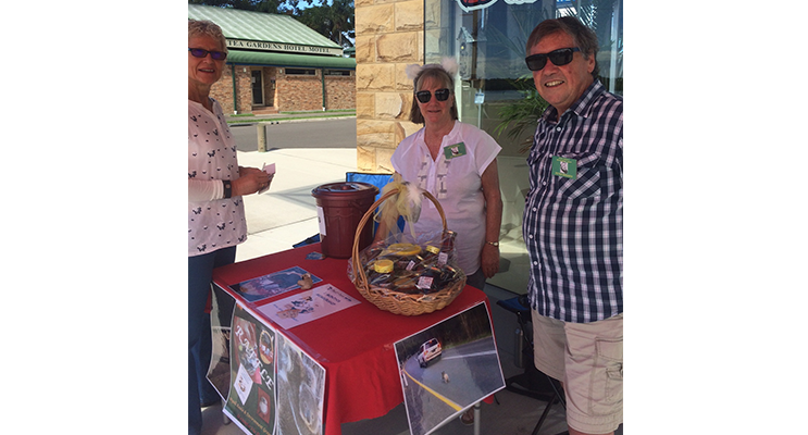 Jill and Peter Madden selling raffle tickets to Adrienne Ingram in Tea Gardens.