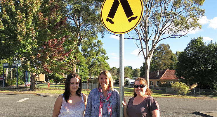 School Crossing Safety: Student Georgia Roberts, Deputy Deb Gilbert and parent Melissa Smith urge drivers to slow down in school zones. 
