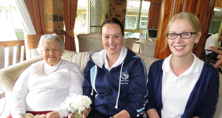 Mother’s Day Visit: Students Shae Finch and Kaitlyn Gregory with resident Fay Skerry-Collins.