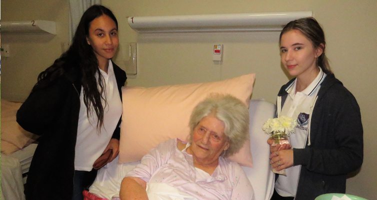 Year 12 students Leah Slockee and Katelyn Sibert visit with resident Hilda Spears.