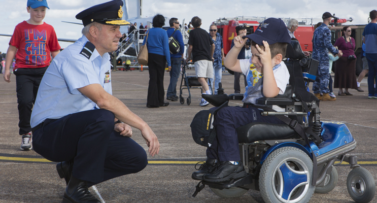 Senior Australian Defence Force Officer at Williamtown, Air Commodore Craig Heap, and five-year-old Josh Ryan who receives support from Muscular Dystrophy NSW.