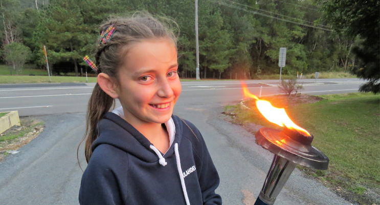 Inspired: Carol Poniris with the Peace Torch in Bulahdelah.