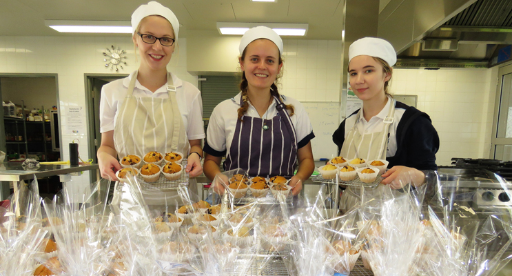 Act Of Kindness: Kaitlyn Gregory, Chelsea Reid and Katelyn Sibert prepare treats to deliver to the community. 