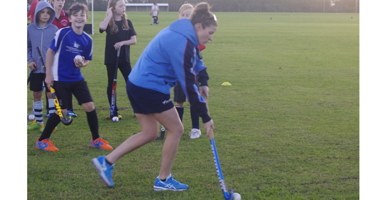 Kate Jenner out in front, with members of the Nelson Bay Hockey Club practising basic skills.