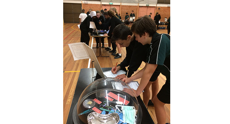 Students examining autopsy results and samples.