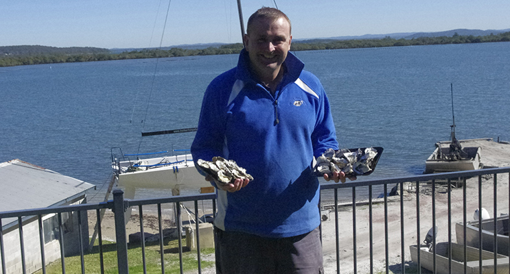 Fifth generation oyster grower Guy Holbert with some Port Stephens Oysters at Soldiers Point.  Photo by BayView Group