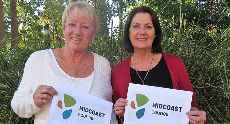 Jennifer Hughes and Julie Worth from Tea Gardens examine the new MidCoast logo. 