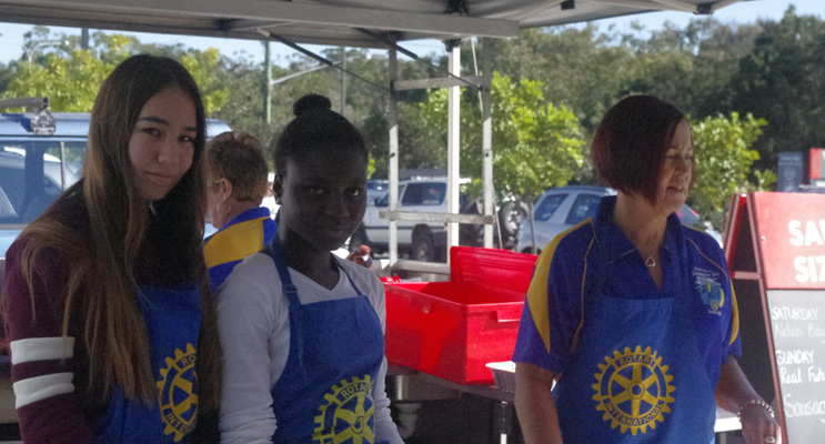 Ambassadors Natasha Schonig-Jenkinson and Taofeekot Kareem, with Rotarian Megan Hayne, at the Bunnings barbecue at Taylors Beach.