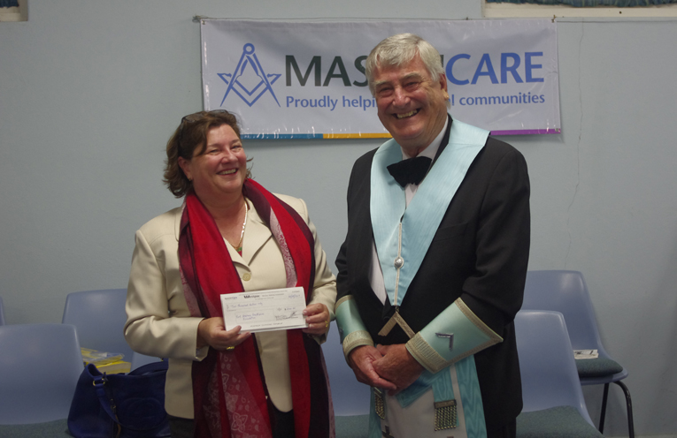 Warrick Lilly of Lodge Cornucopia presents a cheque to fund the project to Real Futures representative Marian Sampson.