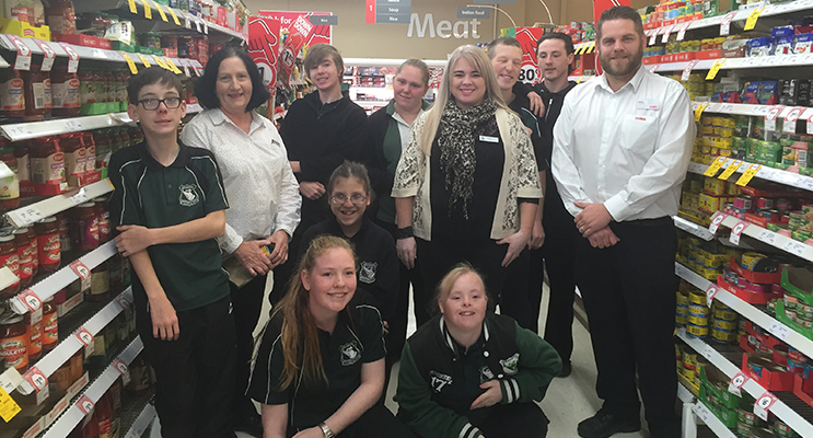 Students and staff from the Learning Support program with relieving Store Manager James Day.