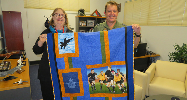 Mrs Jan-Maree Ball presents an Aussie Hero Quilt to Air Commodore Michael Kitcher.