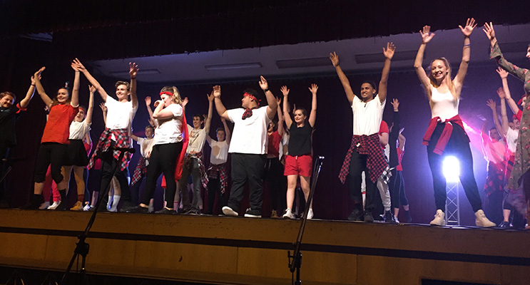 Year 12 students participating in their last showcase perform together and take a bow.