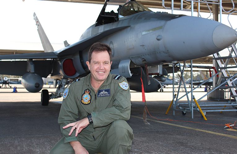 Air Commodore Mike Kitcher in front of an F-A/18 Hornet at Williamtown.