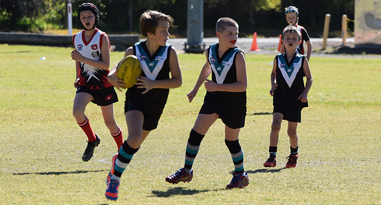 Toby Ruhl and Joel Hay run the ball for Port Hunter. Photos by Michael Gestrin