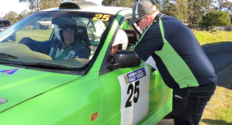AMSAG official Jamie Neale instructs Mitsubishi driver John Fraser and navigator John Paine at Bulahdelah Showground. 