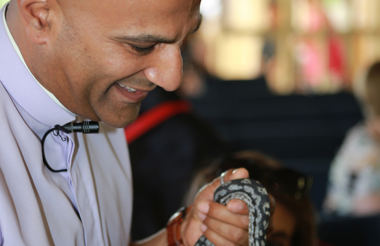 Rev Kesh blessing a snake at the Annual Blessing of the Animals.