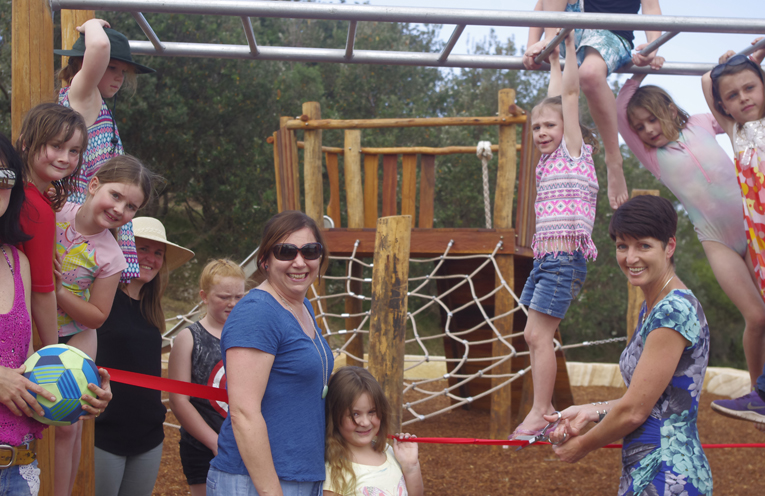 Port Stephens Member Of Parliament Kate Washington Officially Opening the Boat Harbour Playground with a group of local children enjoying the monkey bars.