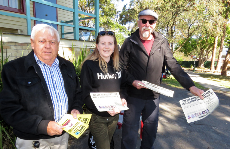 Eric Saville, Holly Ekert and Peter Aulbury distribute how to vote cards in Bulahdelah. 